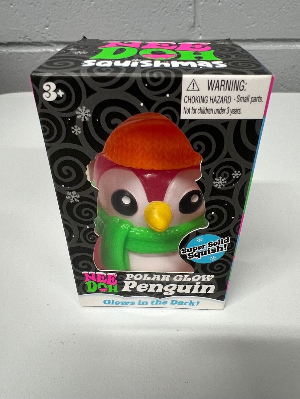 Nee Doh Polar Glow Penguin Squishy Toy - Pink with Orange Hat & Green Scarf